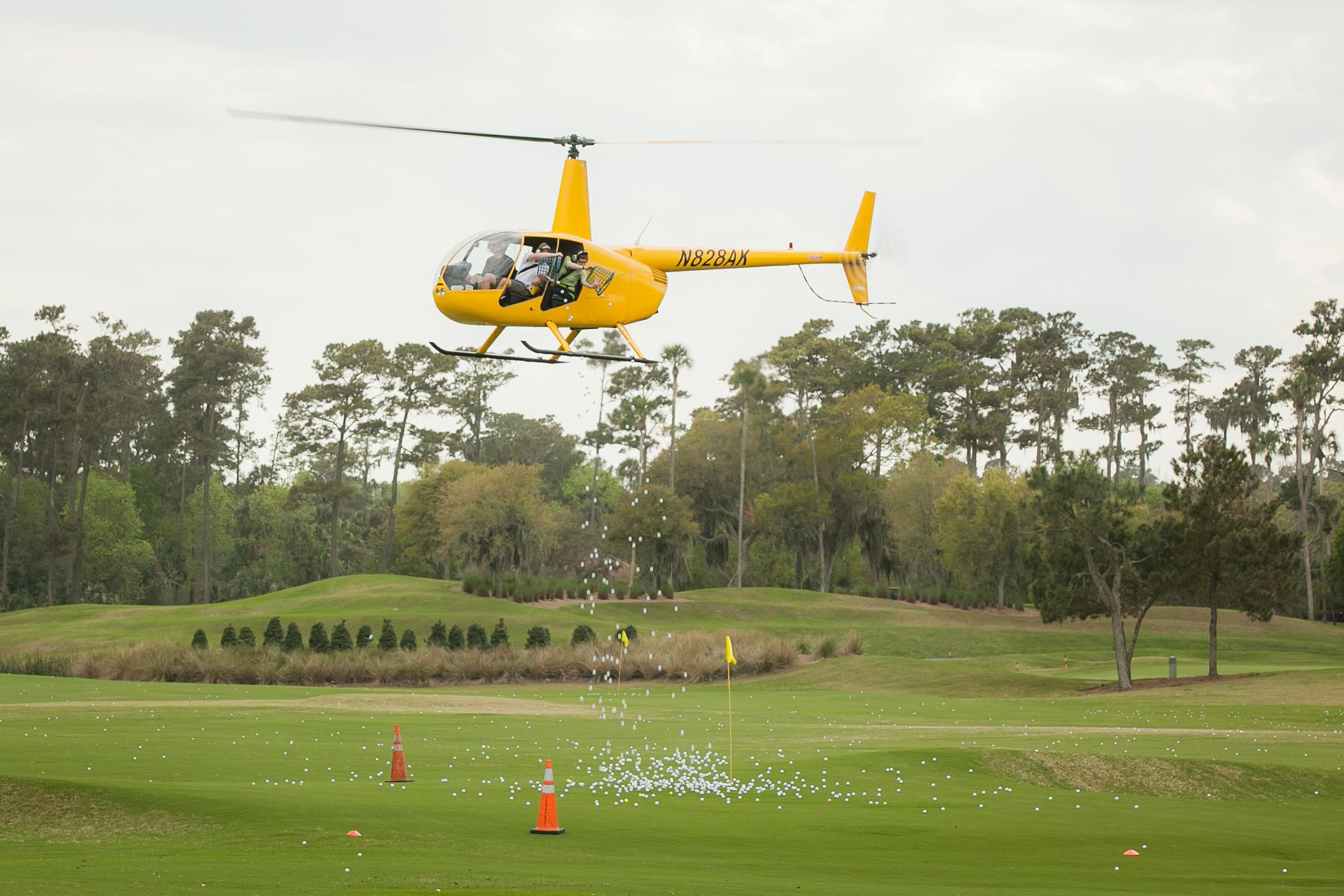 Helicopter releasing golf balls over the green